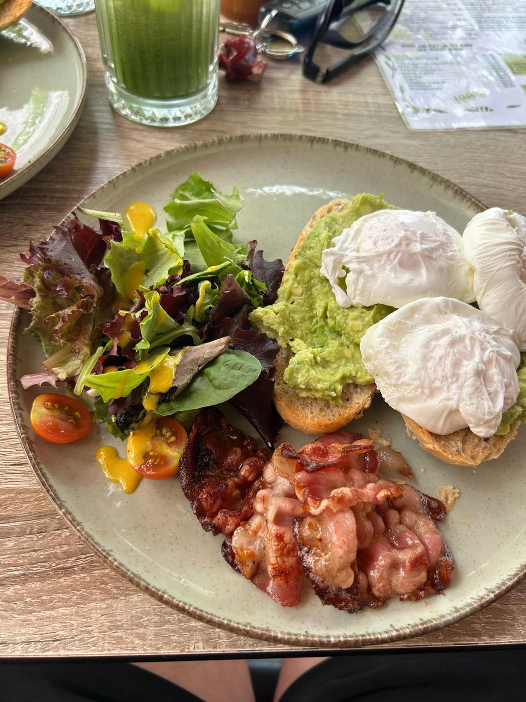 Eggs, avocado toast, bacon and a salad